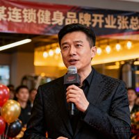某连锁健身房品牌创始人张总在开业典礼上致辞的近景照片